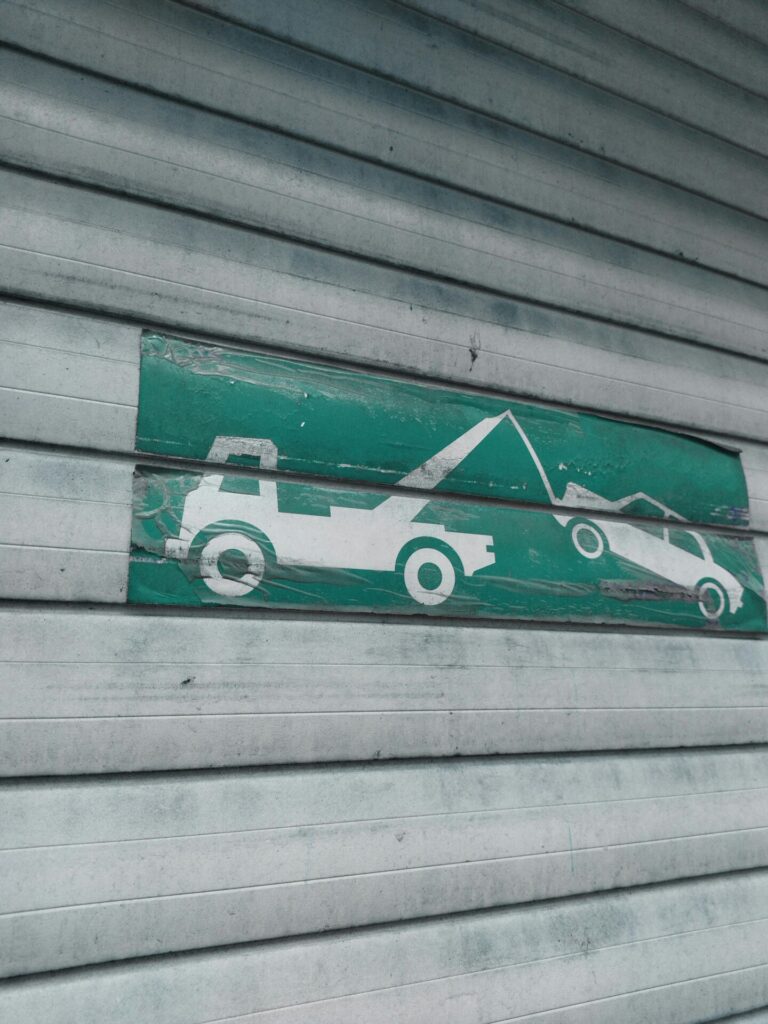 tow truck icon painted on a wall, seen before you scrap your car.